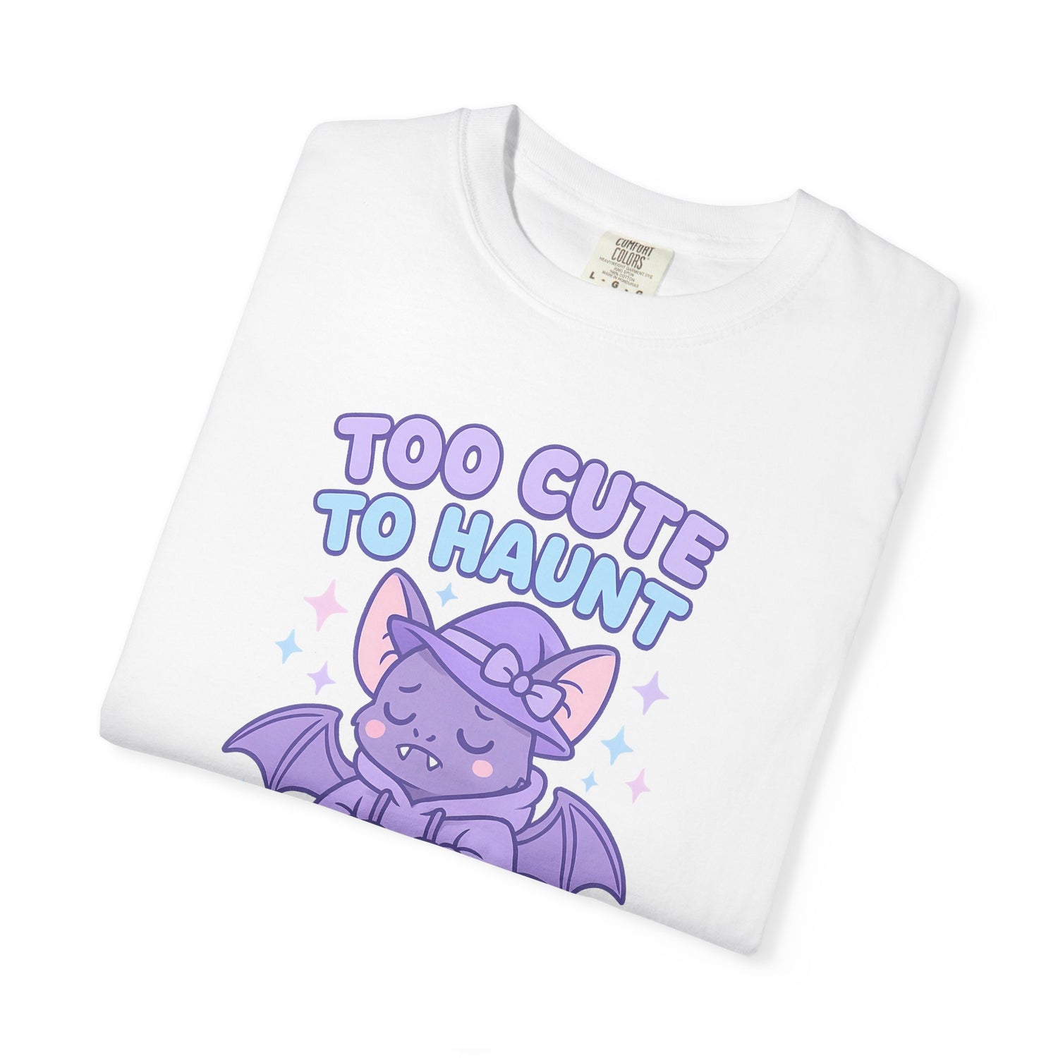 White t-shirt with purple bat graphic and 'Too Cute to Haunt' text on a white background