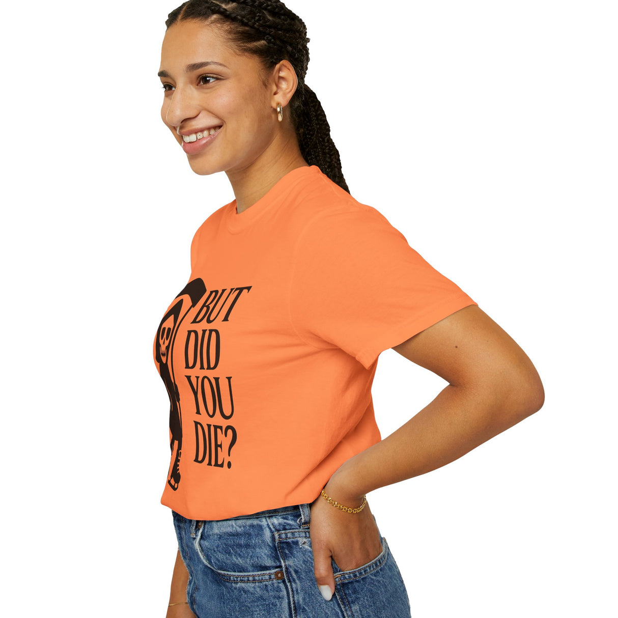 Person wearing an orange t-shirt with text and a graphic design on a white background