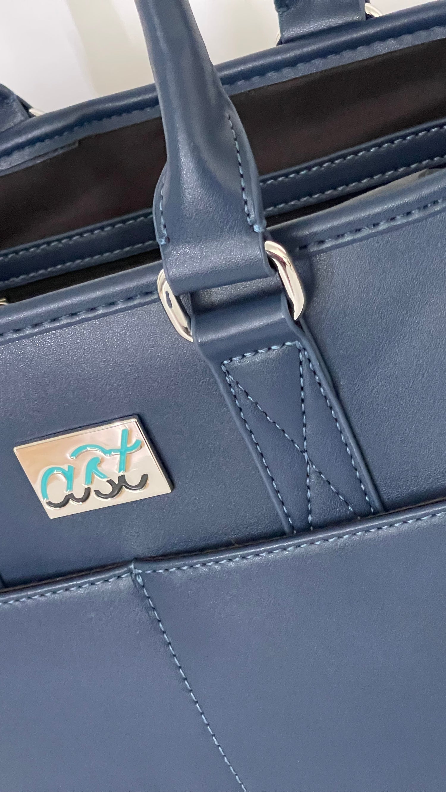 Blue handbag with a visible brand logo on a white background