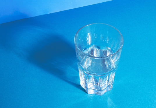 clear-water-glass-reflecting-on-blue
