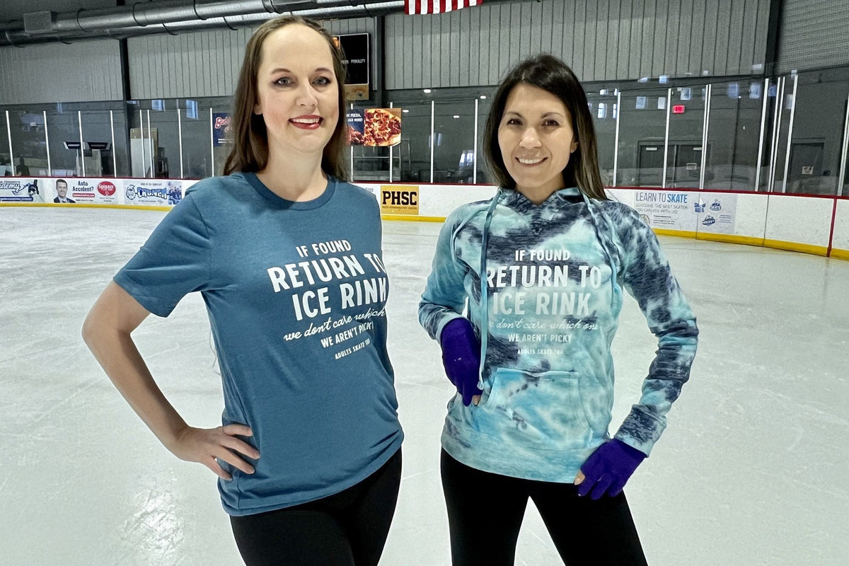Two adult skaters in Adults Skate Too tops standing together on the ice
