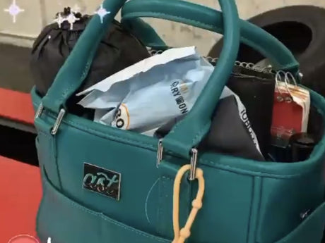 A teal Rink Side Tote packed for a session, with a donut charm on the handle