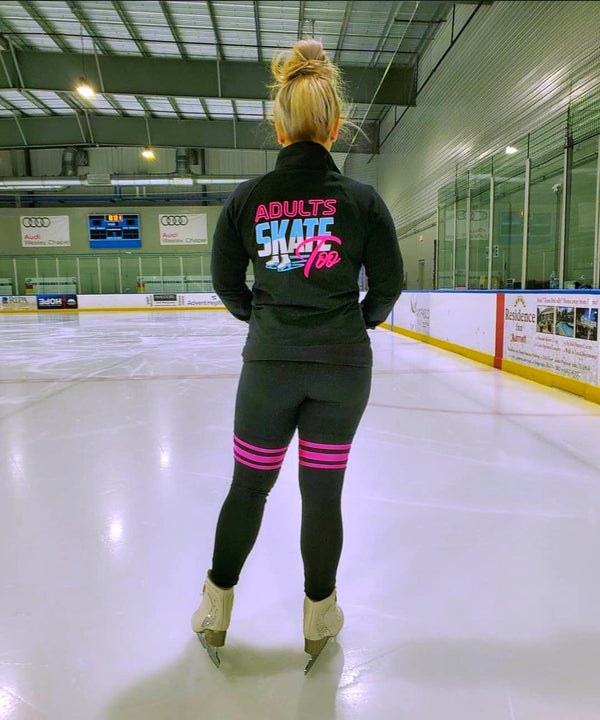 A skater seen from behind in an Adults Skate Too jacket, looking out across the ice.