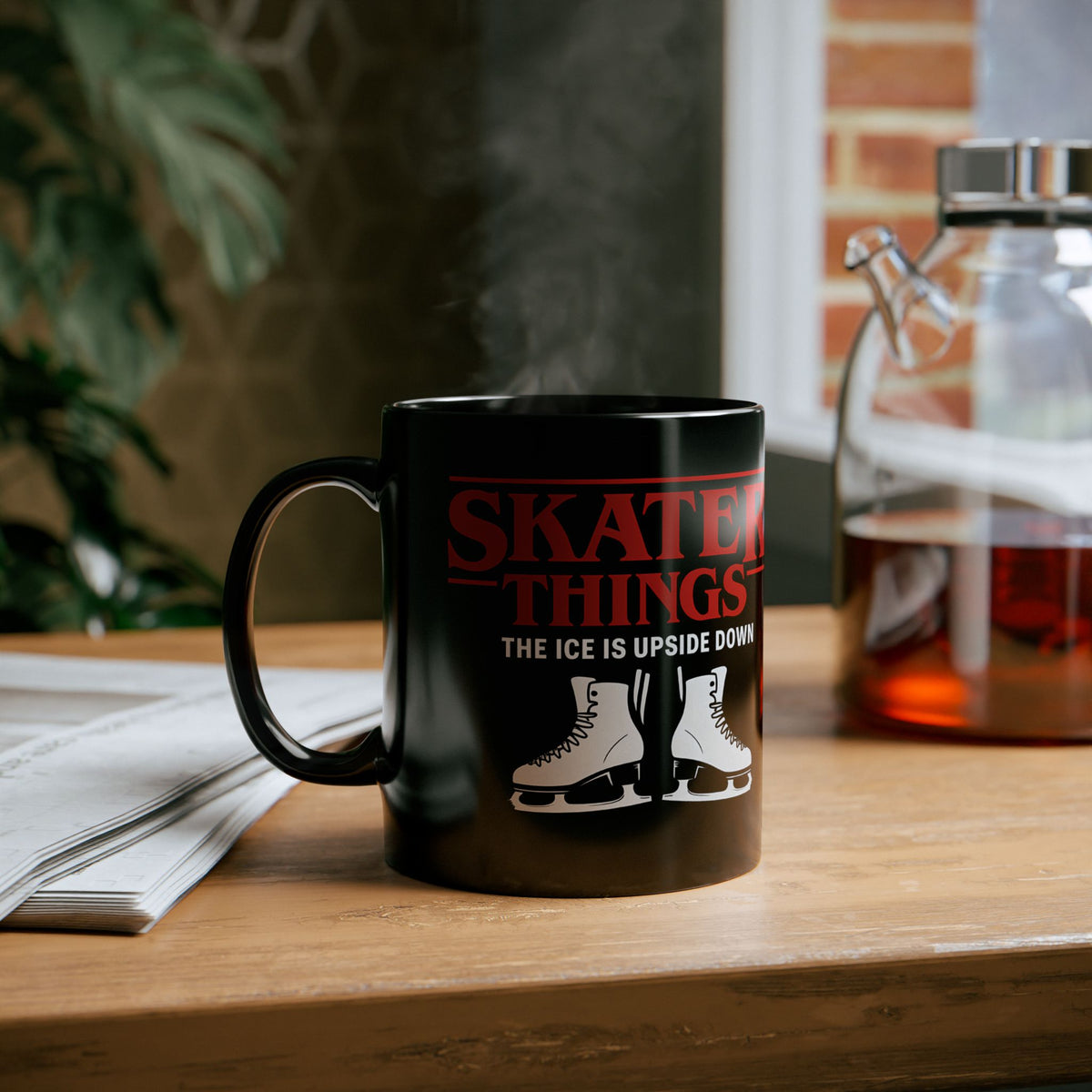 Black mug with 'Skate Things' design on a wooden surface