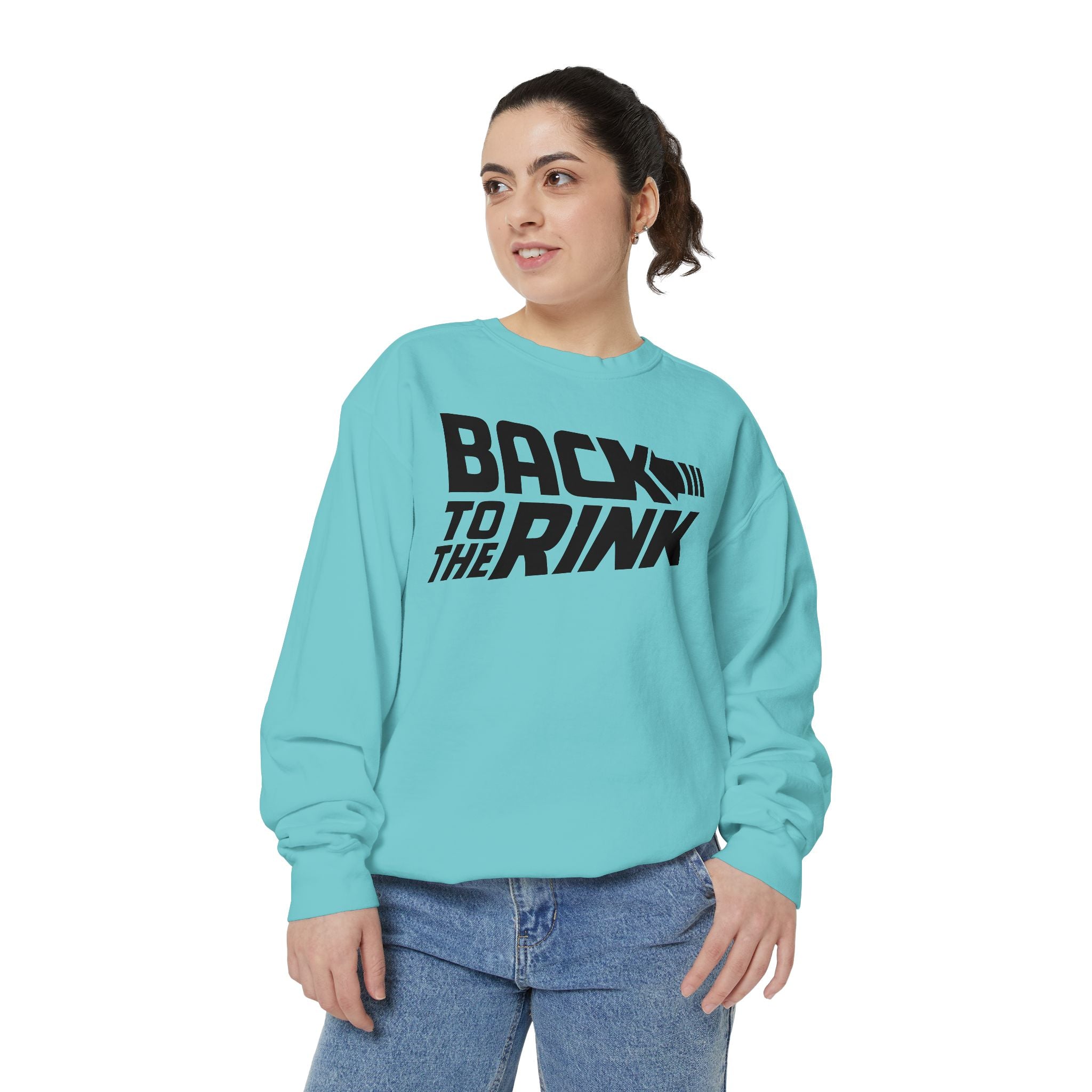 Person wearing a light blue sweatshirt with 'Back to the Rink' text on a white background
