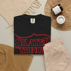 Skater Things T-Shirt in Black, folded on a flat lay with jeans