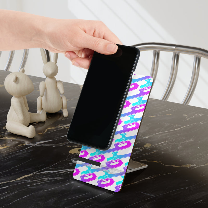 Phone being placed on a colorful phone stand on a marble surface.