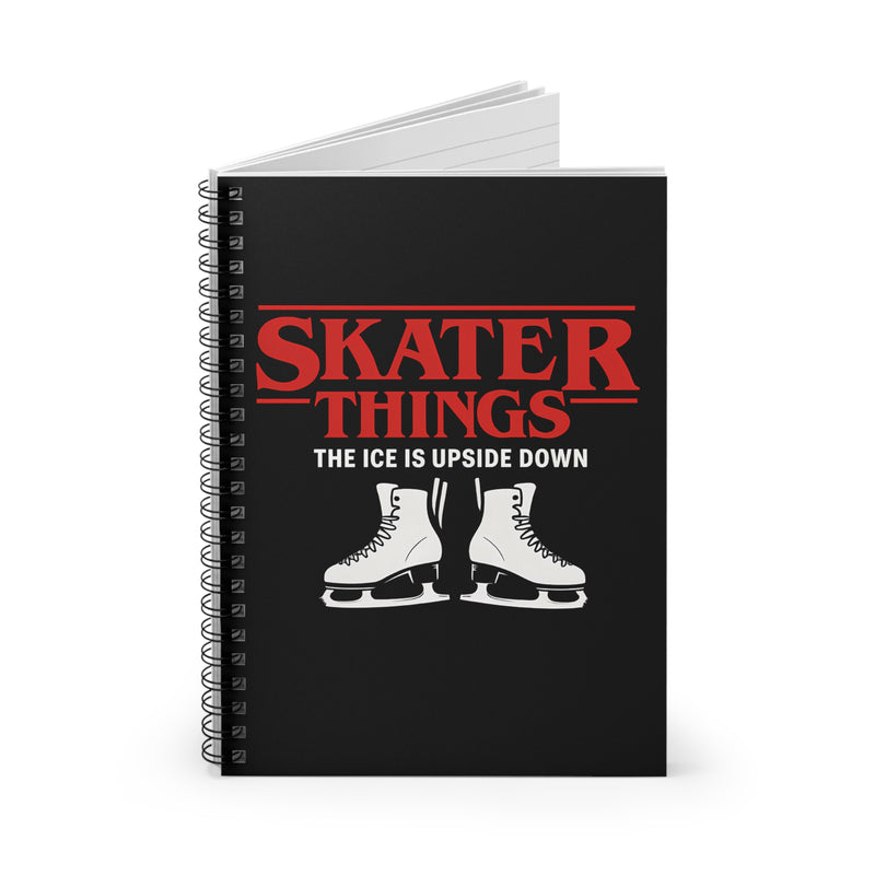 Black notebook with red and white text and skates on a white background