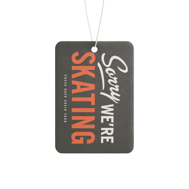 Air freshener with 'Sorry We're Skating' text on a white background
