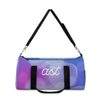 Duffel bag with colorful design and 'ast' branding on a white background