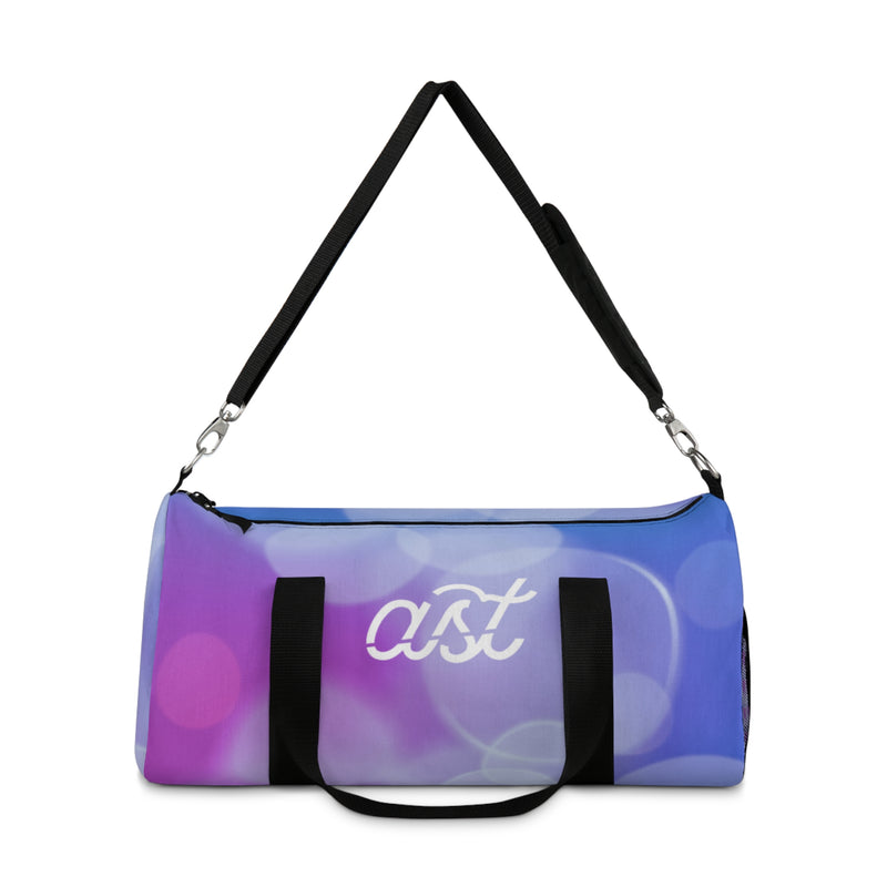 Duffel bag with colorful design and 'ast' branding on a white background