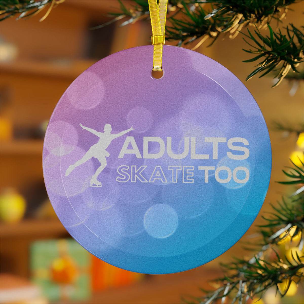 Decorative ornament with 'Adults Skate Too' text and silhouette on a blurred Christmas tree background.