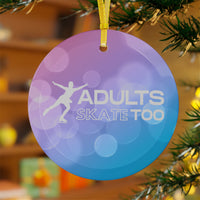 Decorative ornament with 'Adults Skate Too' text and silhouette on a blurred Christmas tree background.