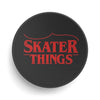 Black circular object with red text 'SKATER THINGS' on a white background