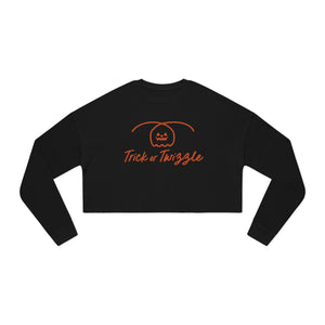 Black long-sleeve crop top with 'Trick or Twizzle' text and pumpkin design on a white background