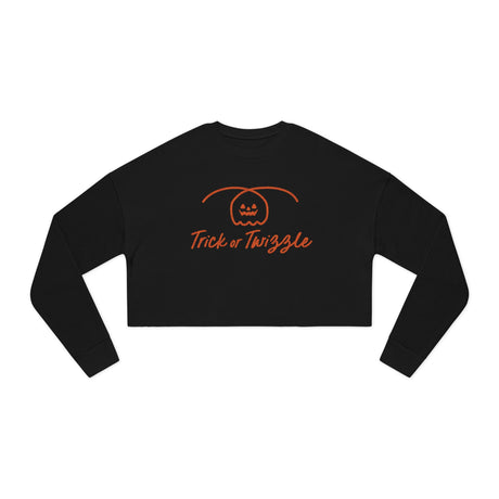 Black long-sleeve crop top with 'Trick or Twizzle' text and pumpkin design on a white background