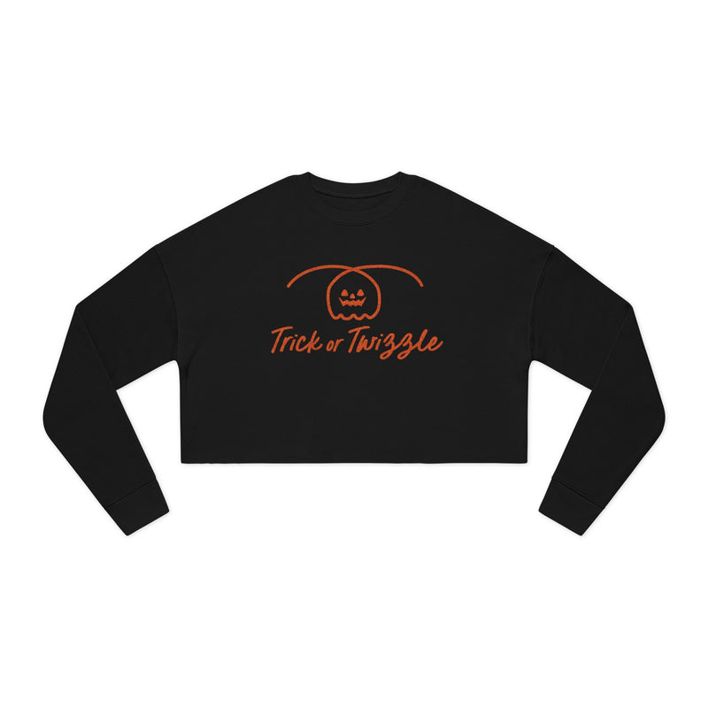 Black long-sleeve crop top with 'Trick or Twizzle' text and pumpkin design on a white background