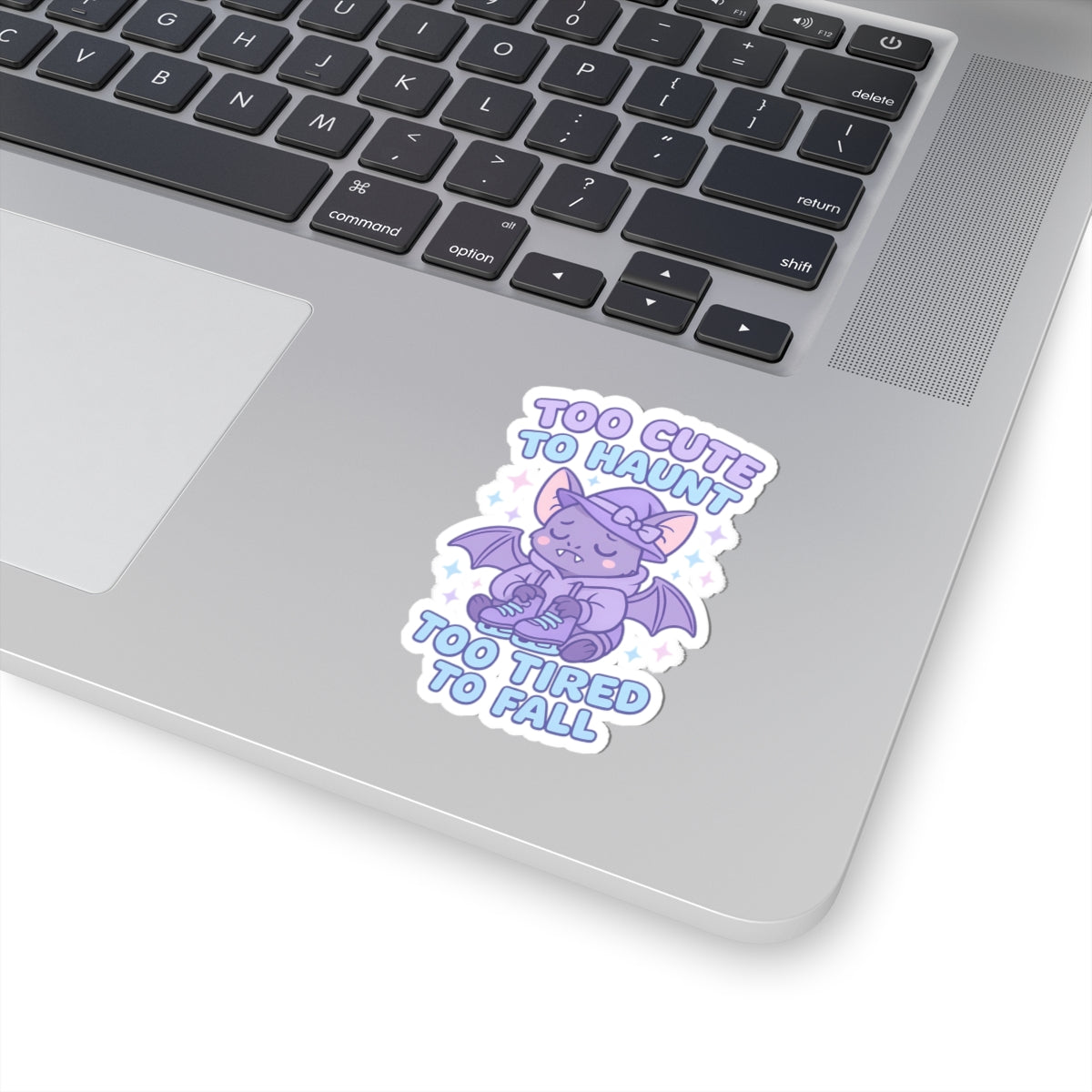 Laptop with a sticker of a cute dragon design on the palm rest area.