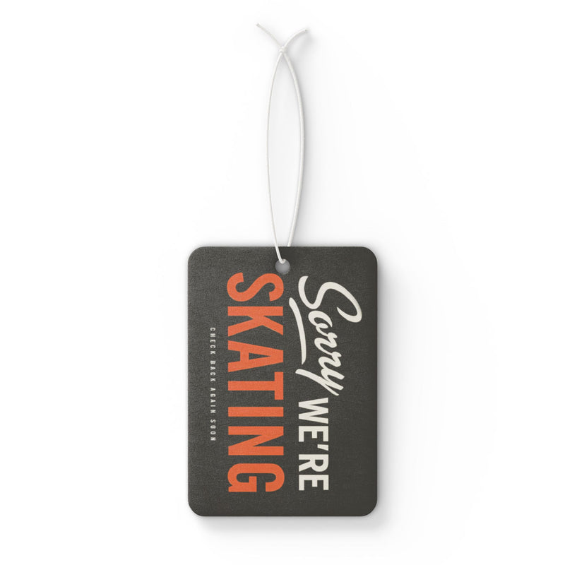 Black luggage tag with orange and white text on a white background