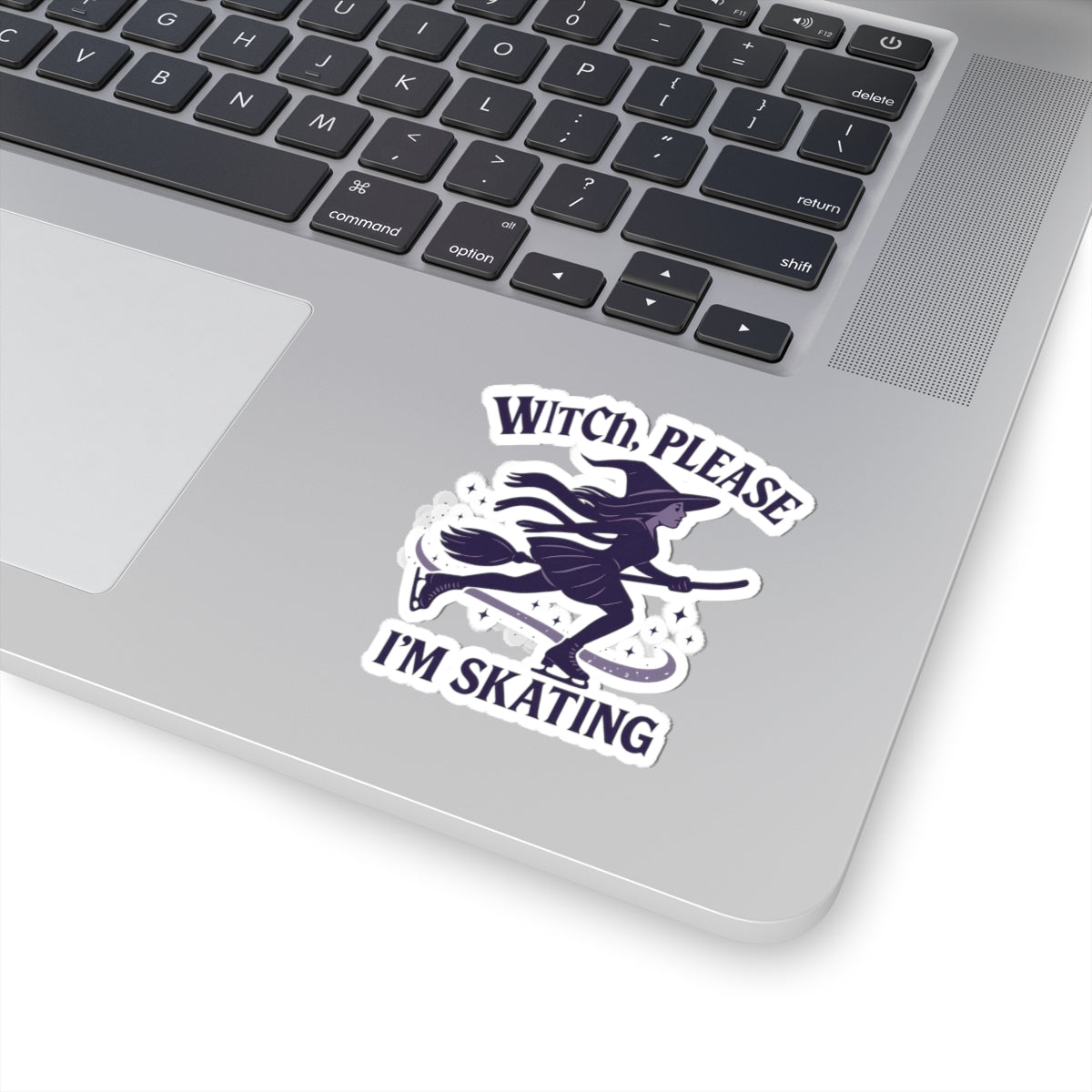 Laptop with a sticker featuring a witch and text 'Witch, Please I'm Skating' on a white background