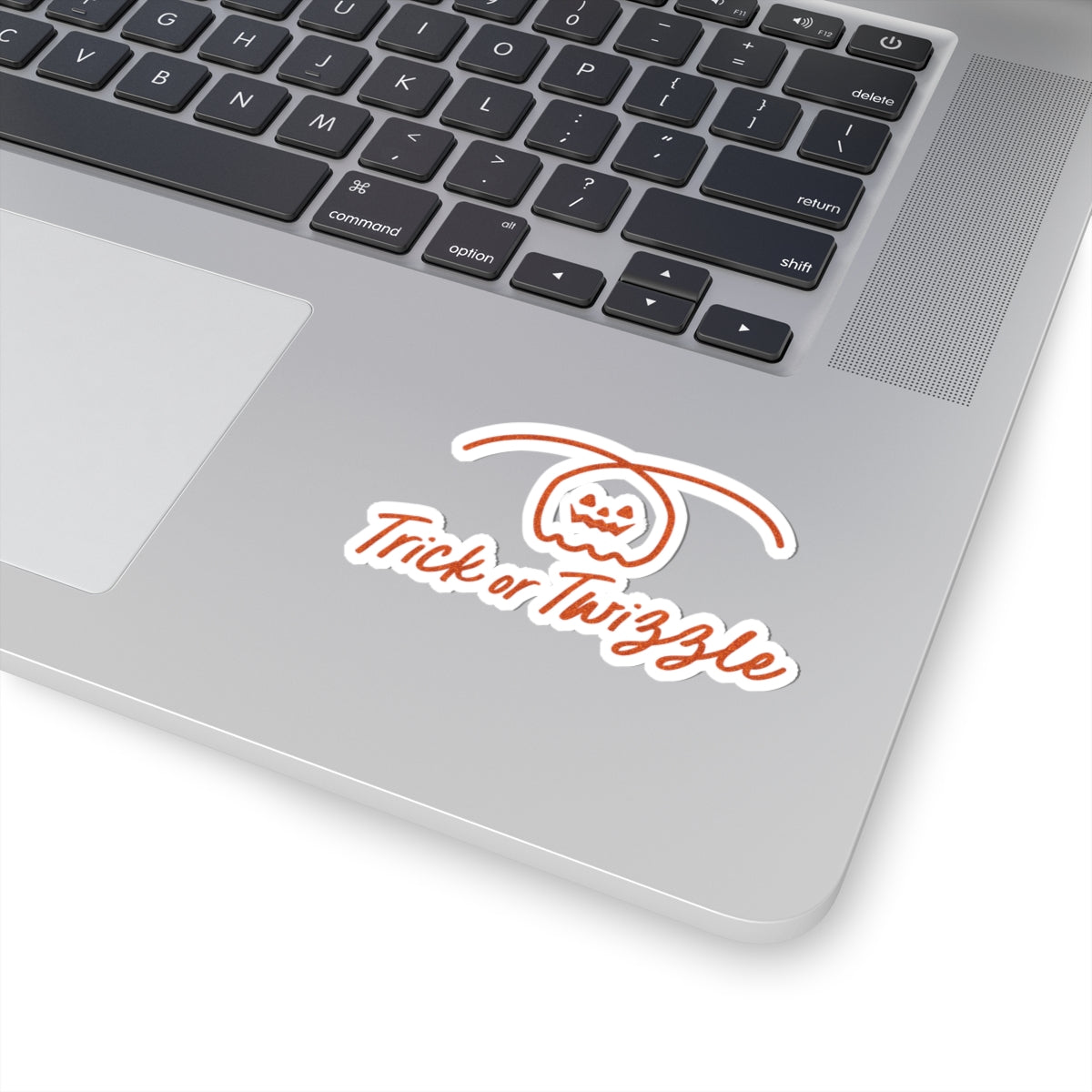 Laptop with a 'Trick or Thwizzle' sticker on the palm rest area