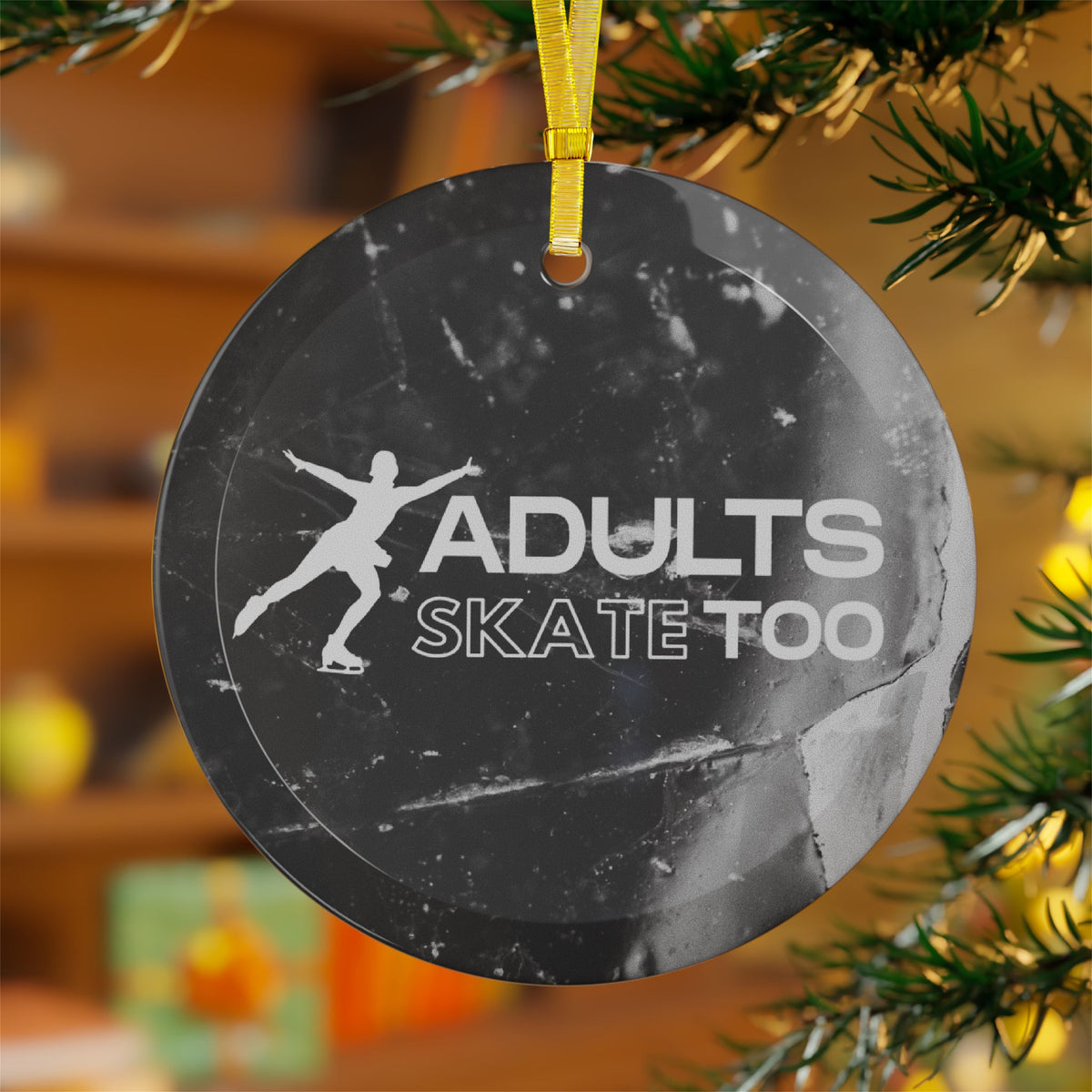 Round ornament with 'Adults Skate Too' text and silhouette of a skater, hanging on a Christmas tree.