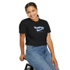 Person wearing a black 'ToePick' t-shirt sitting on a stool against a white background