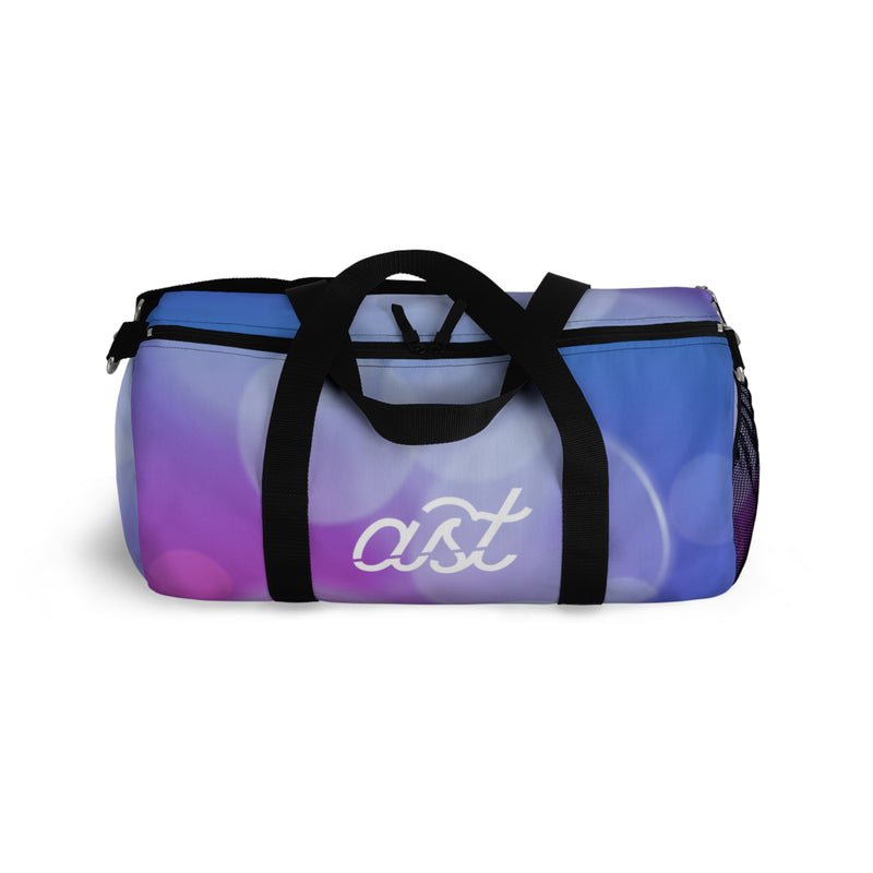 Gradient blue and purple duffel bag with 'ast' logo on a white background