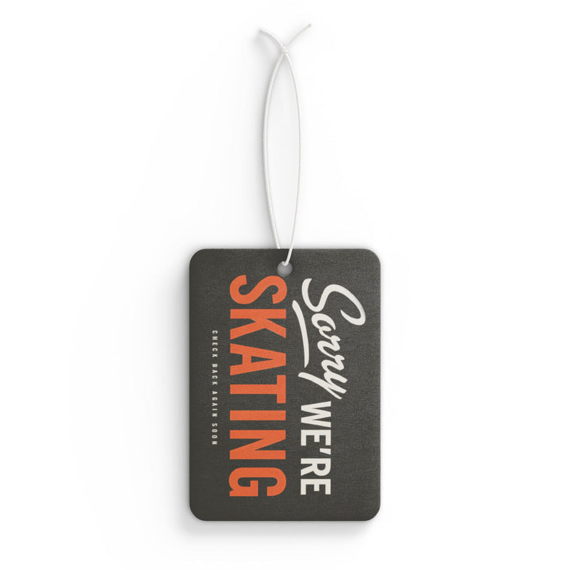 Black luggage tag with 'Sorry We're Skating' text on a white background