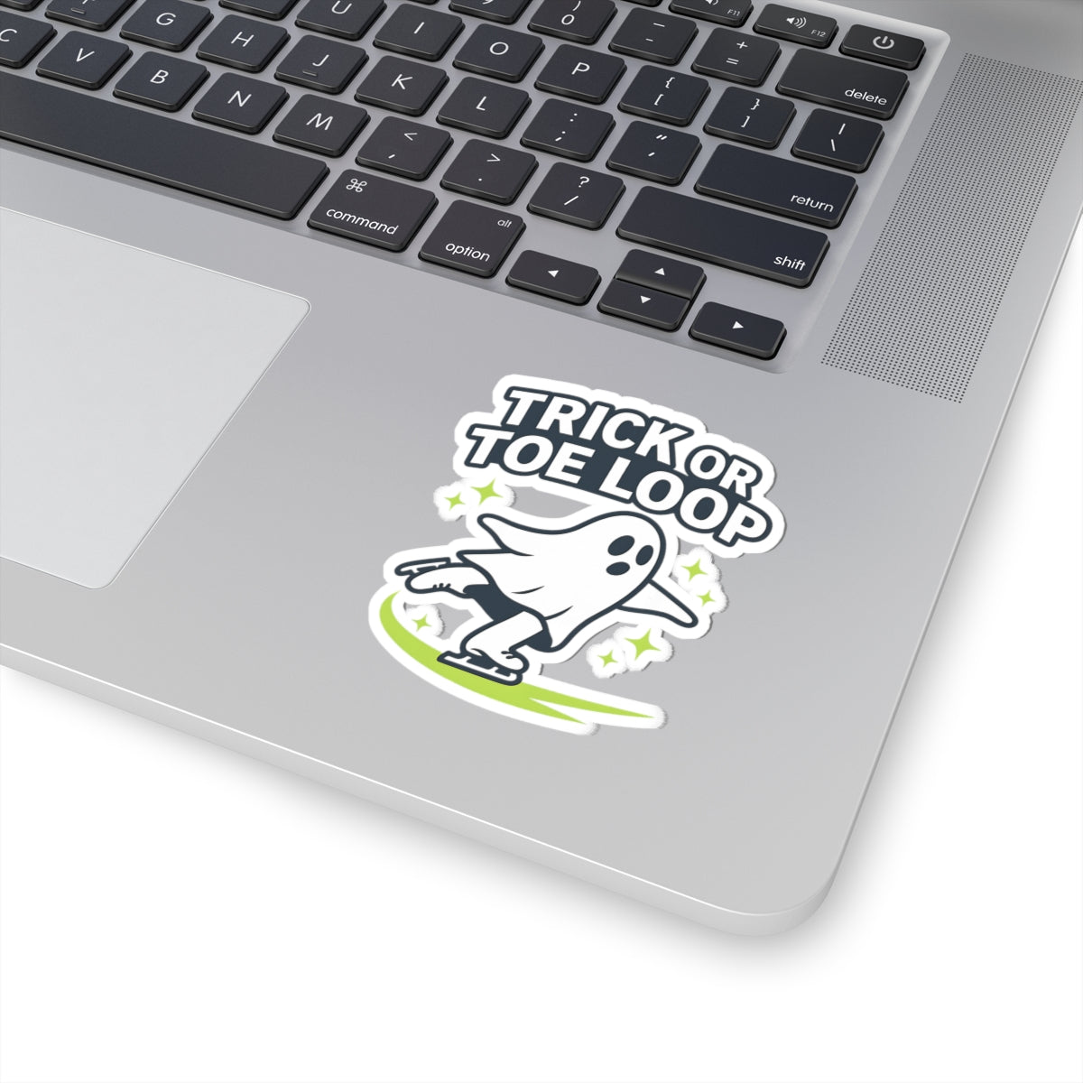 Laptop with a 'Trick or Toe Loop' sticker featuring a ghost character.