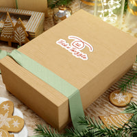 Wooden gift box with a green ribbon and 'Tickle or Twizzle' logo on a festive background with cookies and lights.