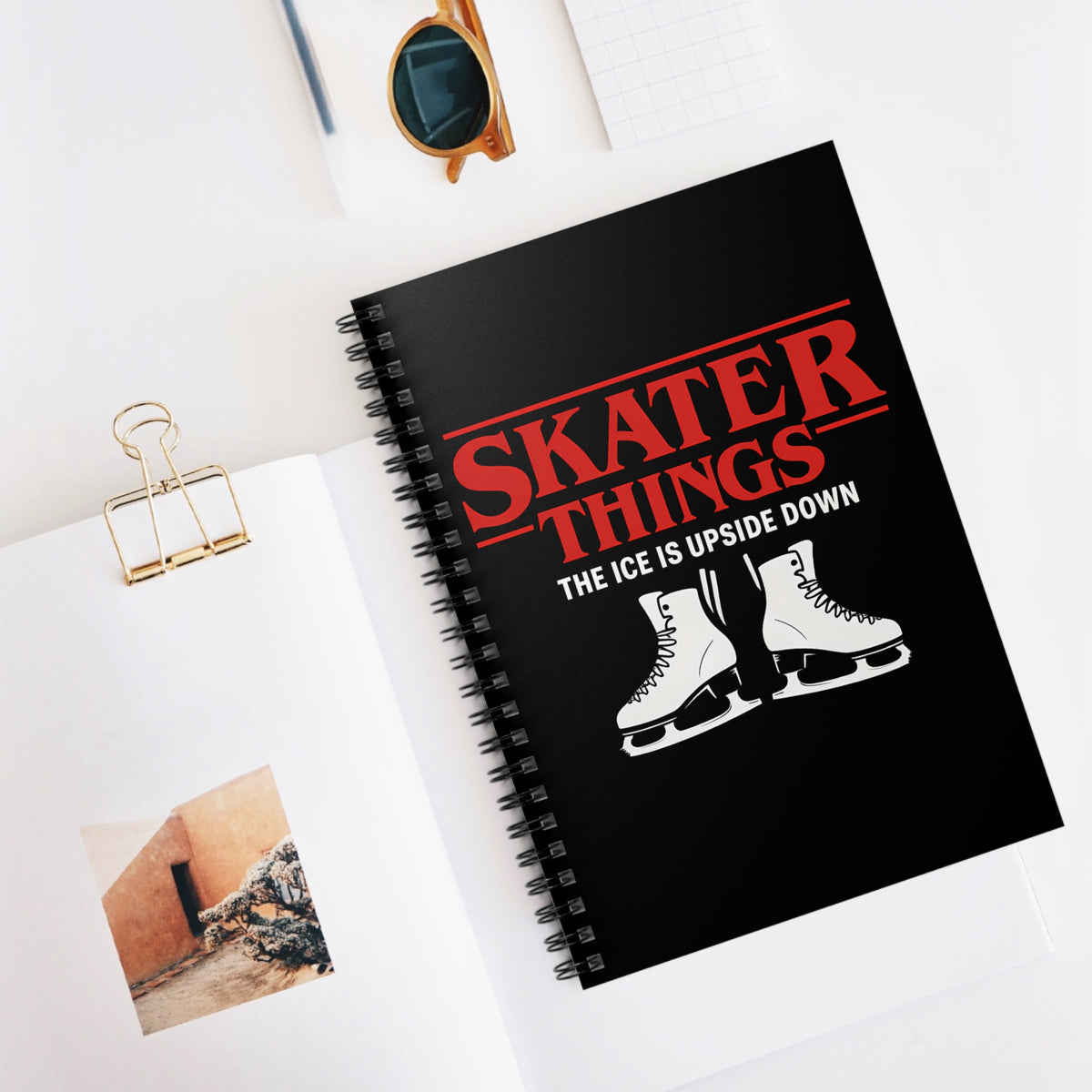Black notebook with 'Skater Things' design on a white surface