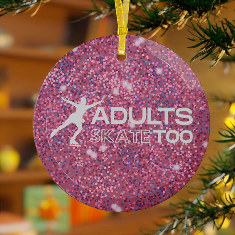 Pink glittery ornament with 'Adults Skate Too' text and silhouette of a skater, hanging on a Christmas tree.