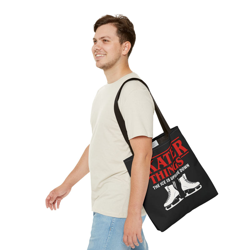 Man carrying a black tote bag with red text and ice skates on a white background