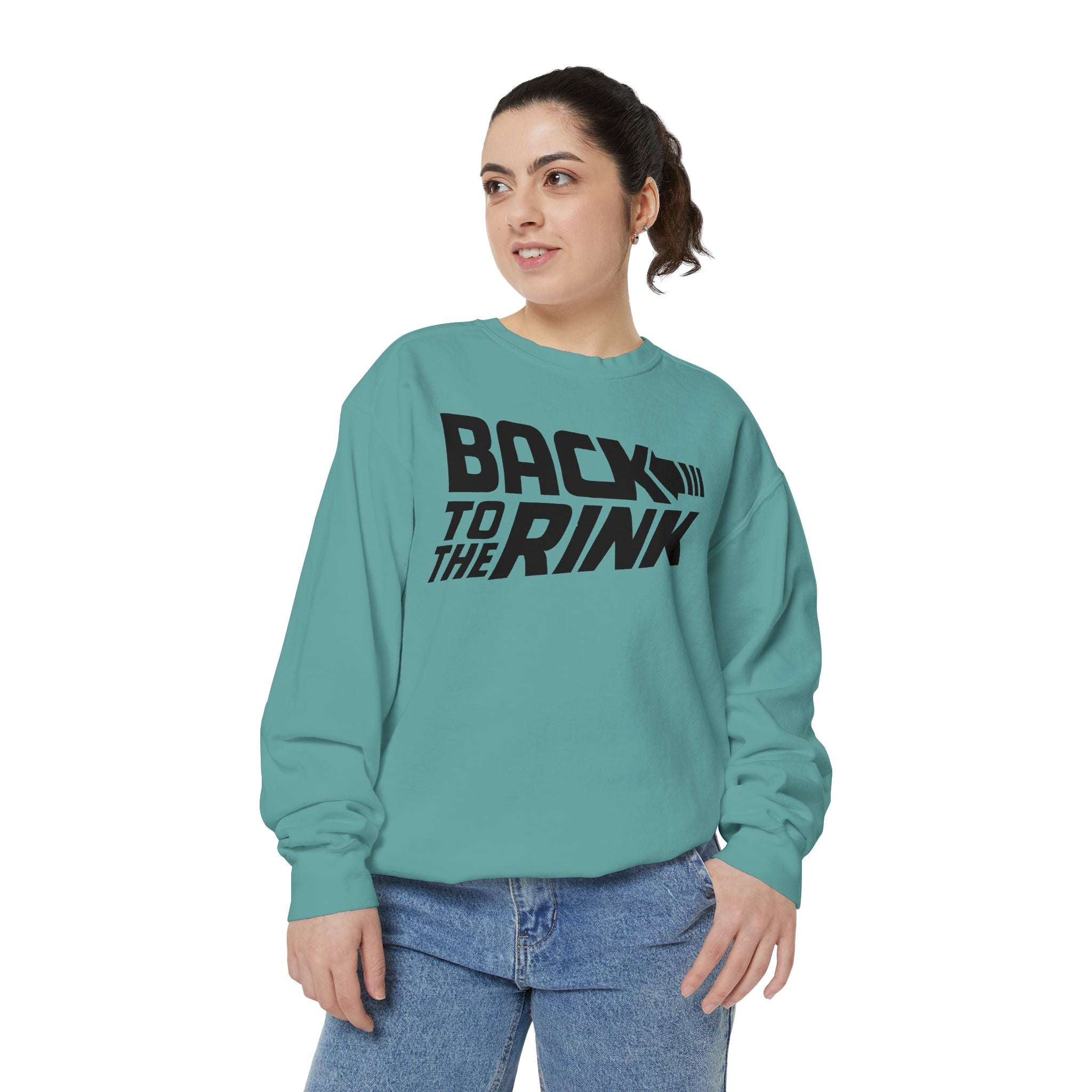 Person wearing a teal sweatshirt with 'Back to the Rink' text on a white background