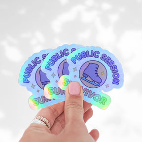 Three Public Session Survivor holographic stickers fanned out in a hand