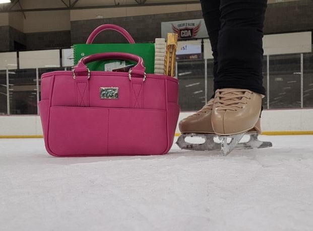 Pink bag on an ice rink with a person in skates nearby