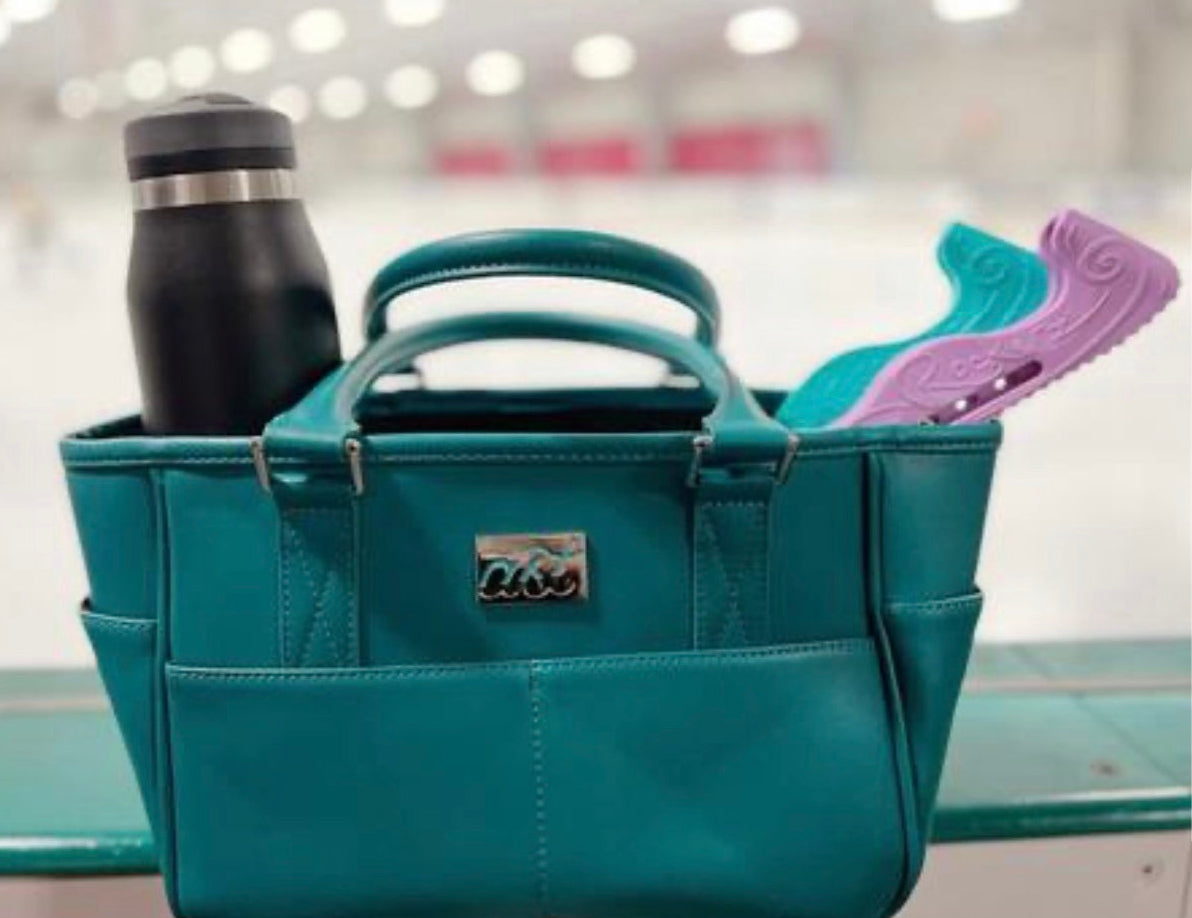 Teal bag with a water bottle and purple shoes on a blurred background