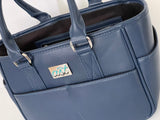Blue handbag with a visible brand logo on a white background