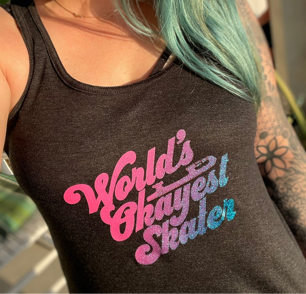 The World's Okayest Skater print in pink and blue on a dark tank top.