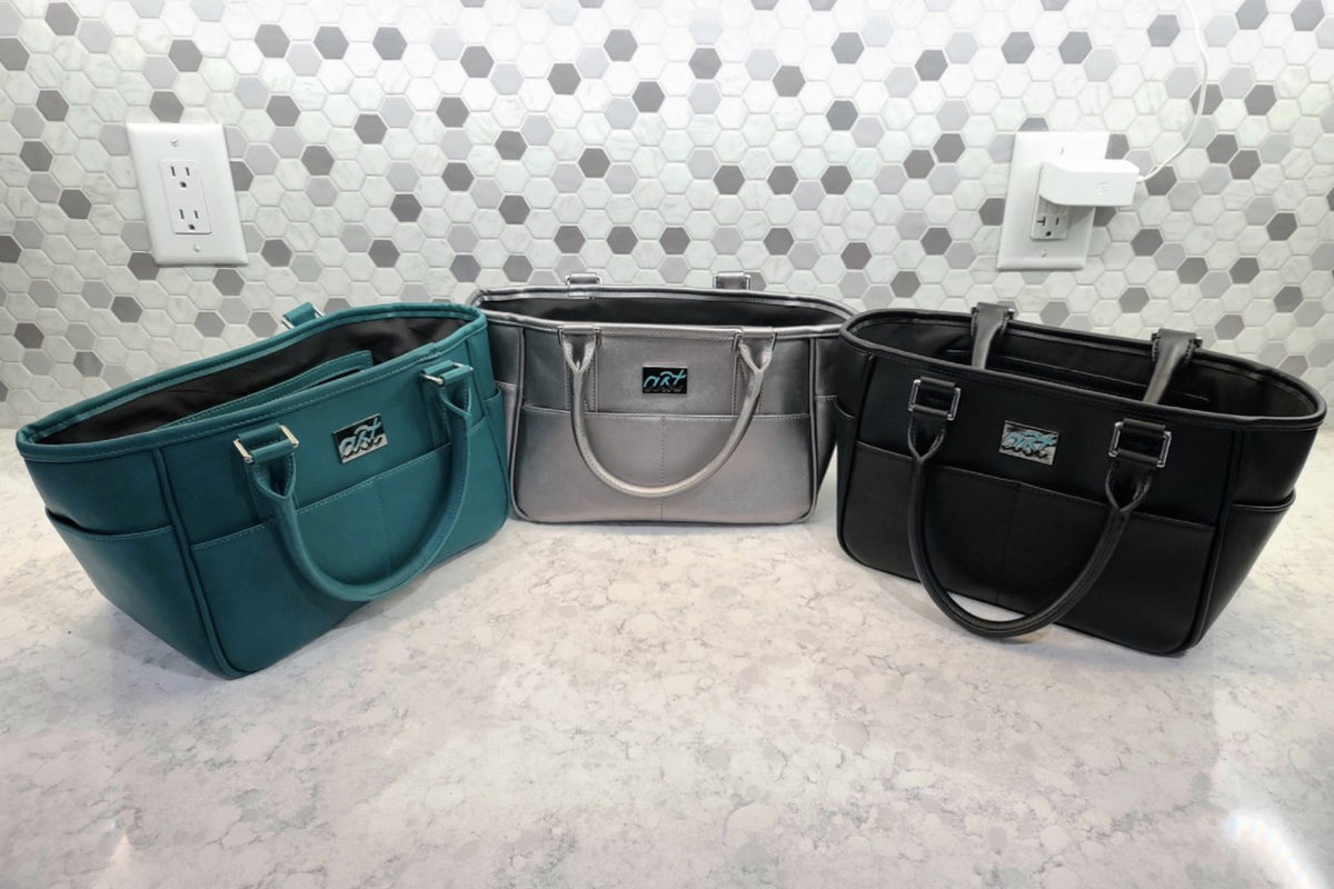 Three Rink Side Totes in teal, silver and black on a counter