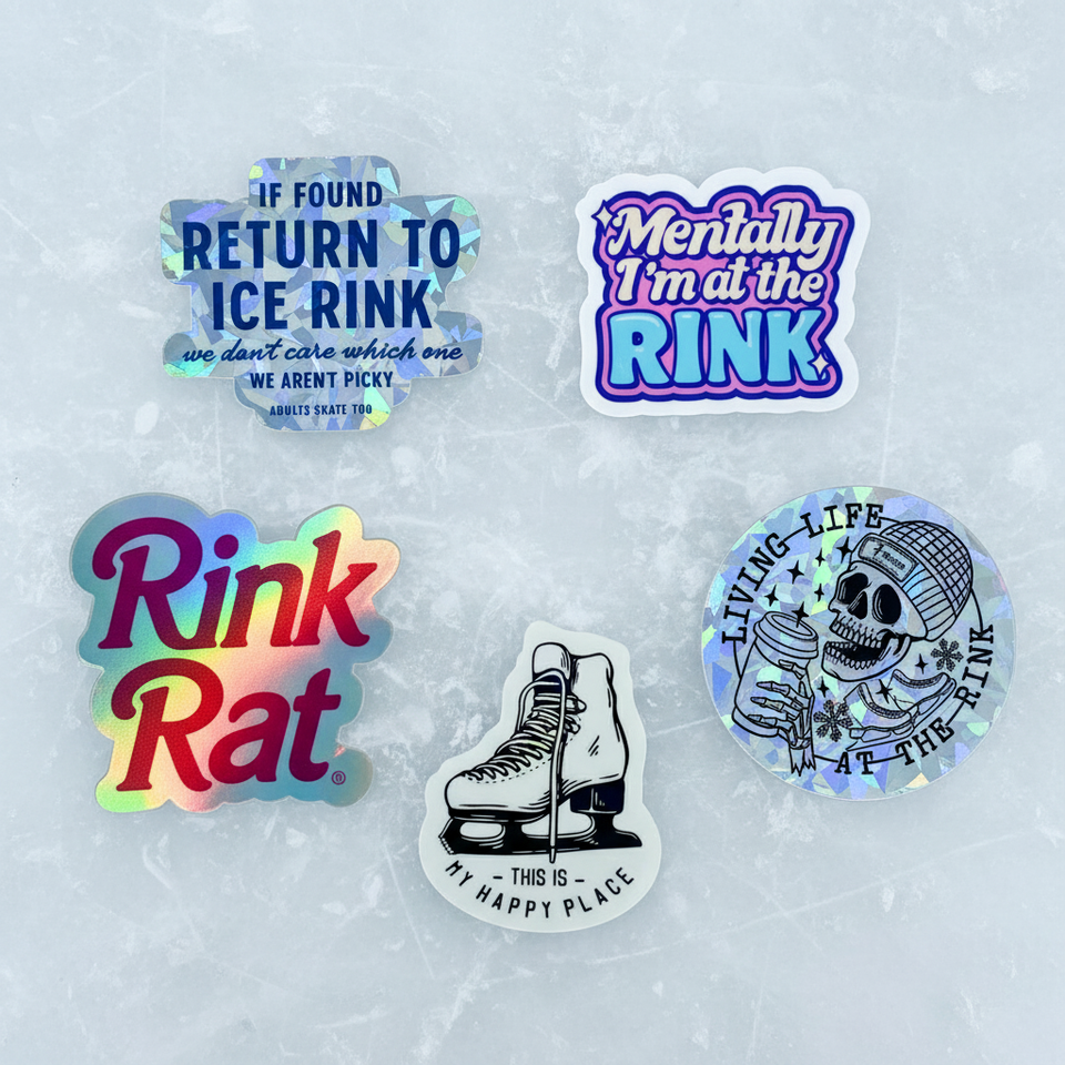 Five AST holographic stickers laid flat on the ice